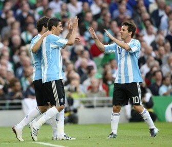 Argentina's Angel Di Maria celebrates with teammate Lionel Messi (R) after scoring against Ireland. AFP