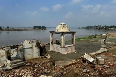 Pakistani flood survivors take shleter in a destroyed structure on the banks of Kabul River in Nowshera. AFP