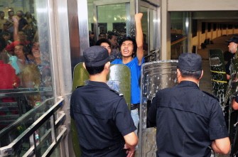 In a file picture taken on August 18, 2010 Chinese riot police move in on a group of angry football fans who rioted after Henan Jianye FC was defeated by Jiangsu Shuntian FC in their 2010 China Football Association (CFA) Super League match in Zhengzhou, central China's Henan province.