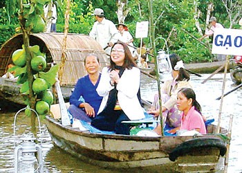 Famous cai luong actress Bach Tuyet (white coat) performs on a boat in Hau Giang Province