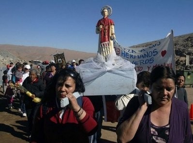 Devotees carry a religious statue during a prayer service for the trapped miners, at the San Jose gold and copper mine in Copiapo, north of Santiago on August 29, 2010