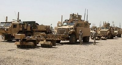 US soldiers stand next to army vehicles during a logistical operation to clear equipment and heavy machinery from the Balad military base, north of Baghdad, on August 27, a week before the US military is due to end its combat mission in the country.