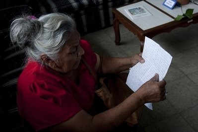 Paula Cruz Martinez, 77, looks at the last letter she received from her son, who she did not name for security reasons, as she visits the Foreign Ministry in search of her son's whereabouts in San Salvador, El Salvador, Monday Aug. 30, 2010.