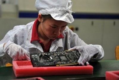 A worker inspects motherboards on a production line in the southern Chinese city of Shenzen.