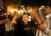Pakistani protesters cry and shout slogans after bomb explosions. AFP