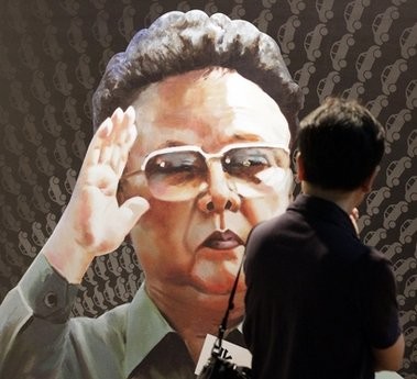 A tourist looks at a poster of North Korean leader Kim Jong Il, painted by North Korean defector Sun Moo, at the Korea War Memorial Museum in Seoul, South Korea, Tuesday, Sept. 7, 2010