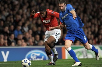 Antonio Valencia (L) is tackled by Rangers' Scottish defender Kirk Broadfoot during their UEFA Champions League game at Old Trafford in Manchester on September 14, 2010. AFP