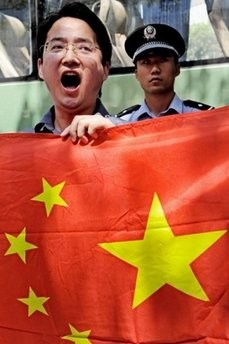 A Chinese demonstrator shouts slogans near the Japanese consulate during a protest in Shanghai on September 18, 2010.