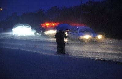A man stands in flood waters brought on Typhoon Megi in the north eastern town of Yilan, Taiwan, Thursday, Oct. 21, 2010 as it passes south of the island to China.