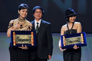 Actress Nhat Kim Anh (L) and the representative of Hong Kong actress Fiona Sit receive the Best Actress Awards.