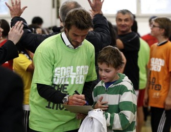 England 2018 Bid Ambassador and former England captain David Beckham signs autographs during his visit to a school in Zurich on November 30, 2010. AFP