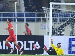 Vietnam striker Nguyen Anh Duc (L) celebrates after scoring with a header a goal as Myanmar goalkeeper Thiha Si Thu falls down at their match in Hanoi on December 2 (AFP photo)