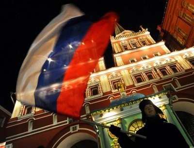 A local supporter waves the Russian national flag as he celebrates after FIFA President Joseph Blatter announced on December 2, in Zurich, that Russia will host the 2018 World Cup.