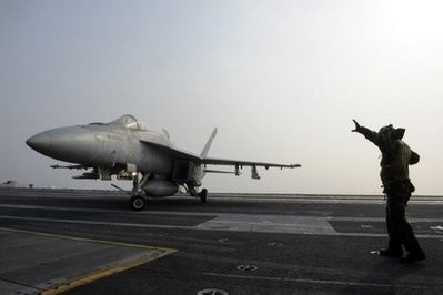 A F/A-18E Super Hornet lands on the deck of the aircraft carrier USS George Washington during a joint Naval exercise with South Korea in the Yellow Sea, on November 30, 2010