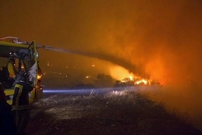 Israeli firefighters try to extinguish a raging fire in the city of Kyriat Karmel, Carmel Forest