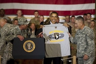 US commander in Afghanistan General David Petraeus (left) introduces US President Barack Obama as he holds up a 101st Airborne T-shirt at Bagram Air Base in Afghanistan during a surprise visit for the holidays