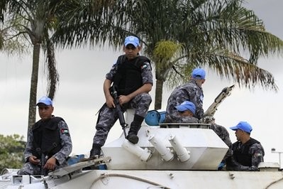 Jordanian United Nations soldiers stand guard at the entrance to the Golf Hotel in Abidjan, Ivory Coast, Sunday, Dec. 5, 2010