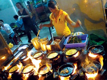 Banh Xeo sizzles on the hot pans