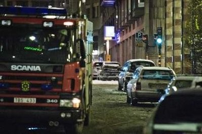 A fire truck is seen near the wreckage of a car after a blast in the centre of Stockholm December 11, 2010.