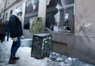A passer-by stand stands on December 12, 2010 at the corner of Bryggaregatan and Drottninggatan street in central Stockholm. AFP