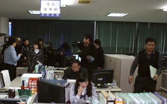South Korean employees of Insung Corporation work after an accident of one of their ships, a South Korean fishing boat, the 614-ton Number One Insung, at the company in the southern port city of Busan on December 13, 2010. AFP