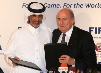 FIFA president Sepp Blatter (R) and Qatar Football Association (QFA) president, Sheikh Hamad bin Khalifa bin Ahmed al-Thani, pose with documents after officially appointing Qatar as the host of the 2022 FIFA World Cup in Doha on Dec. 16. AFP