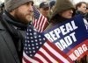 Activists listen during a rally on Don't Ask, Don't Tell on Capitol Hill, December 10.