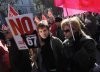 A boy holds a placard reading, No to retirement at 67 during a rally in Madrid