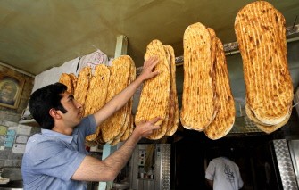An Iranian baker displays loaves of bread at a bakery in central Tehran on December 19, 2010 as the Iranian government began to implement its controversial plan of scrapping subsidies on energy and food products as part of the reforms which had been in the pipeline for several years. AFP