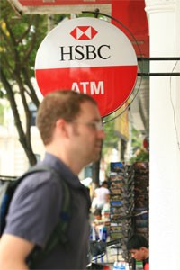A foreigner waits outside an ATM booth in Ho Chi Minh City (Photo:Minh Tri)