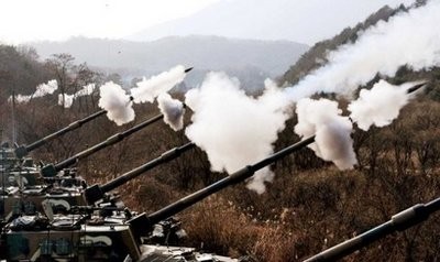 South Korean Army K-9 155mm self-propelled Howitzers fire live rounds during joint air and ground military exercises on the Seungjin Fire Training Field, in mountainous Pocheon.