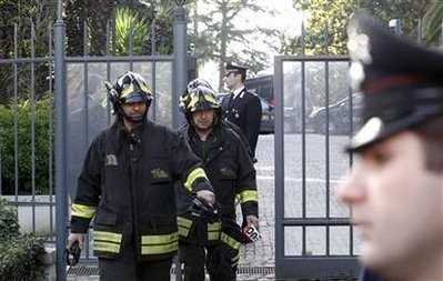 Firefighters walk out of the Swiss embassy downtown in Rome, December 23, 2010