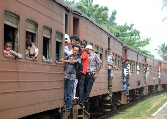 Sri Lankan passengers on board train in Colombo on December 26, 2010. Six years earlier, in December 2004 during the Asian tsunami, some 31,000 people died on the island and one million were initially left homeless. AFP