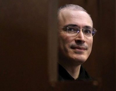 Former Yukos oil company CEO Mikhail Khodorkovsky stands behind a glass wall in a courtroom, in Moscow, October 2010
