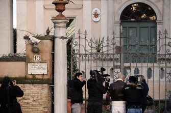 Cameramen and journalits stand in front of Finland's embassy to the Vatican on December 27, 2010 in Rome, after a suspect package has been found and declared a false alarm. AFP