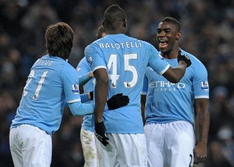 Manchester City's Micah Richards (R) celebrates with Mario Balotelli (2nd R) after he had scored their fourth goal for his hat-trick. AFP