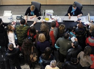 Hundreds of people crowd around information stands at Moscow's Domodedovo airport paralyzed by bad weather, on December 28, 2010