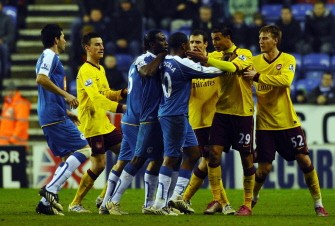 Arsenal's forward Marouane Chamakh (2-R) confronts Wigan Athletic's midfielder Charles N'Zogbia (4-R) who is then sent off by referee Lee Probert after a foul on Arsenal's English midfielder Jack Wilshere (unseen). AFP