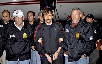 This Nov. 16, 2010 file photo provided by the Drug Enforcement Administration, shows Russian arms trafficking suspect Viktor Bout, center, in U.S. custody.