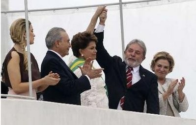 Brazil's President Dilma Rousseff is honored by outgoing President Luiz Inacio Lula da Silva after receiving the presidential sash outside Planalto Palace in Brasilia January 1, 2011.