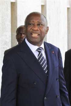 Incumbent Ivory Coast leader Laurent Gbagbo stands after a meeting in Abidjan December 28, 2010