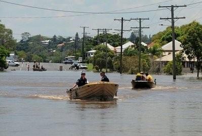 Police patrol the streets for looters by boat after the Fitzroy River broke its banks and inundated much of Rockhampton.