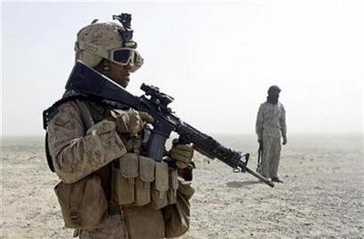A U.S. Marine patrols with a member of an Afghan border guard unit in the desert of the lower Helmand River valley, in southern Afghanistan in this July 1, 2009 file photo