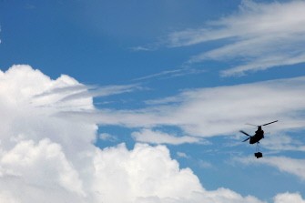 An Army Chinook helicopter leaves Australia's Rockhampton transporting an electricity generator to the flood disaster area of Theodore on January 6, 2011. More heavy rains were forecast for Australia's northeast, threatening to worsen flooding after besieged Rockhampton cut supplies to "irresponsible" residents refusing to leave. AFP