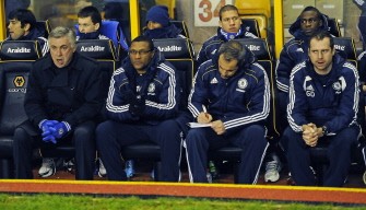 Carlo Ancelotti (L) is pictured with his coaching staff before the match between Wolverhampton Wanderers and Chelsea. AFP