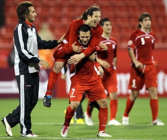 Iran's players celebrate after beating Iraq in Doha on January 11, 2011. Iran won 2-1. AFP