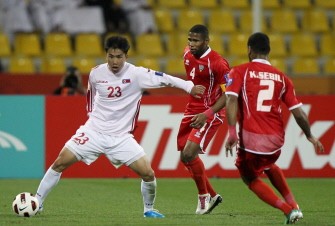 North Korea's midfielder Kim Kuk-Jin (L) tries to get away with the ball from UAE's midfielder Subait Khater (C) and defender Khaled Lashkari (R) during their match in Doha on January 11, 2011. AFP