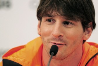 Messi looks on during the presentation of his new boots in a sports shop on January 13, 2011 in Barcelona. AFP