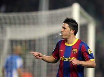David Villa spits as he celebrates his goal during the match FC Barcelona vs Malaga CF on January 16, 2011. Barcelona won 4-1. AFP
