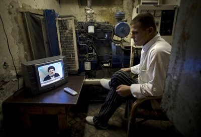 A man watches the speech of Hezbollah leader Hassan Nasrallah in Beirut, Lebanon, Sunday, Jan. 16, 2011.